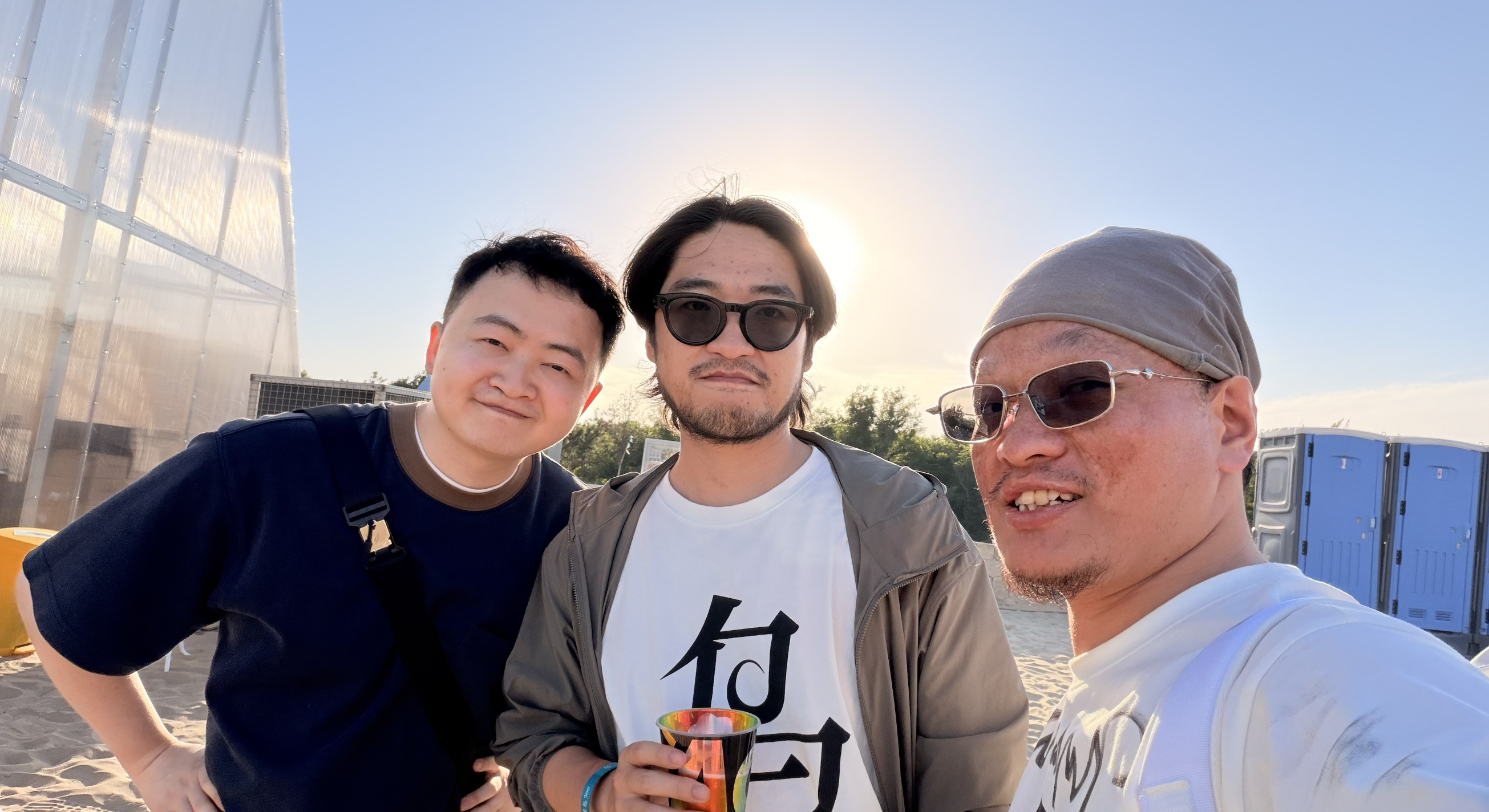 Source image for Three Friends Posing for a Golden Hour Selfie at a Sandy Outdoor Festival